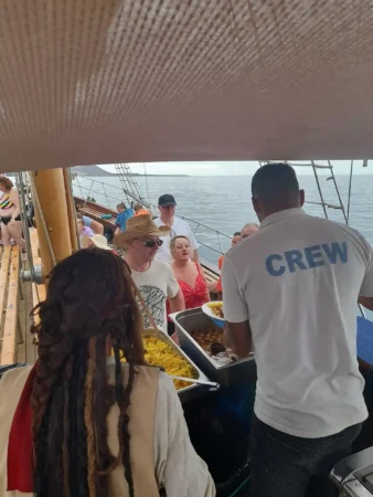 Crew and pirate serving food aboard the Peter Pan ship