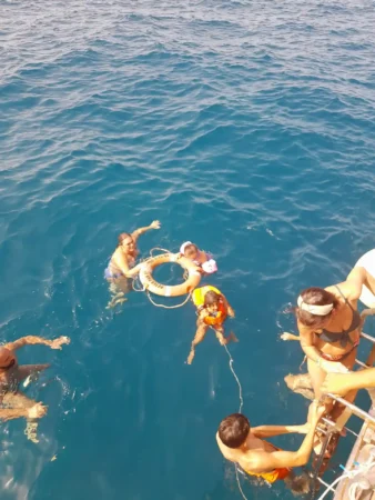 Family bathing in the sea in the Peter Pan Boat